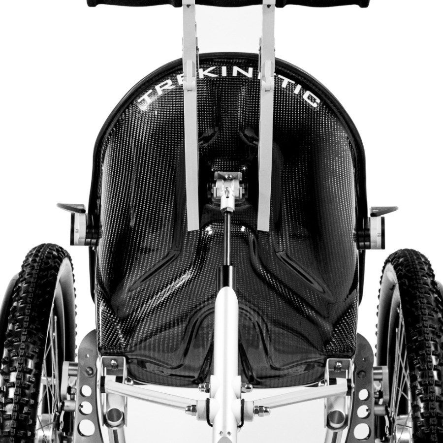 Close up on rear of Trekinetic K2 wheelchair showing folding handlebars and nitrogen shock absorber