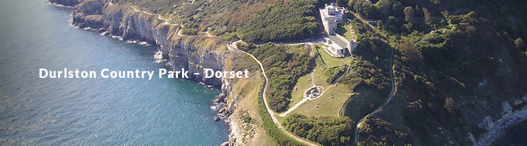 A Picture of the coast of Durlston-Country-Park, with a heading reading "Durlston-Country-Park"