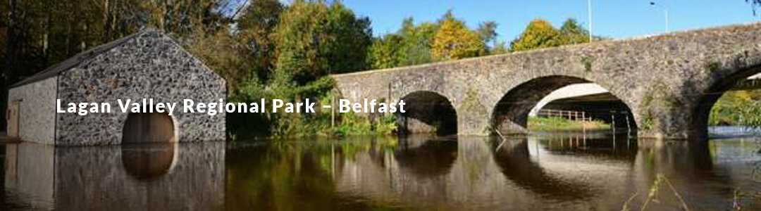 A picture of a stone arching bridge over a river. with a heading reading "Lagan Valley Regional Park"