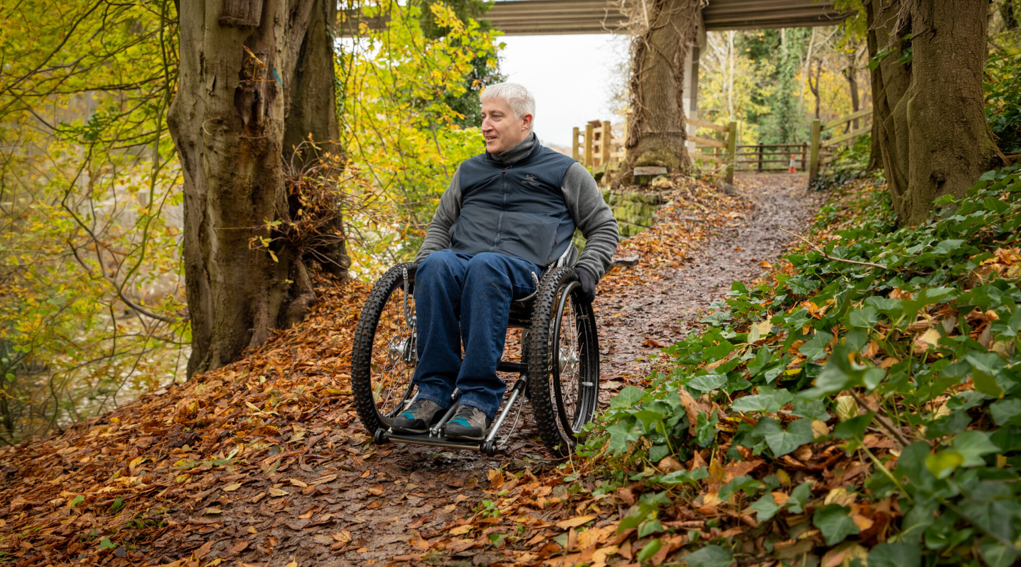 man rolling down a leafy path in his K2