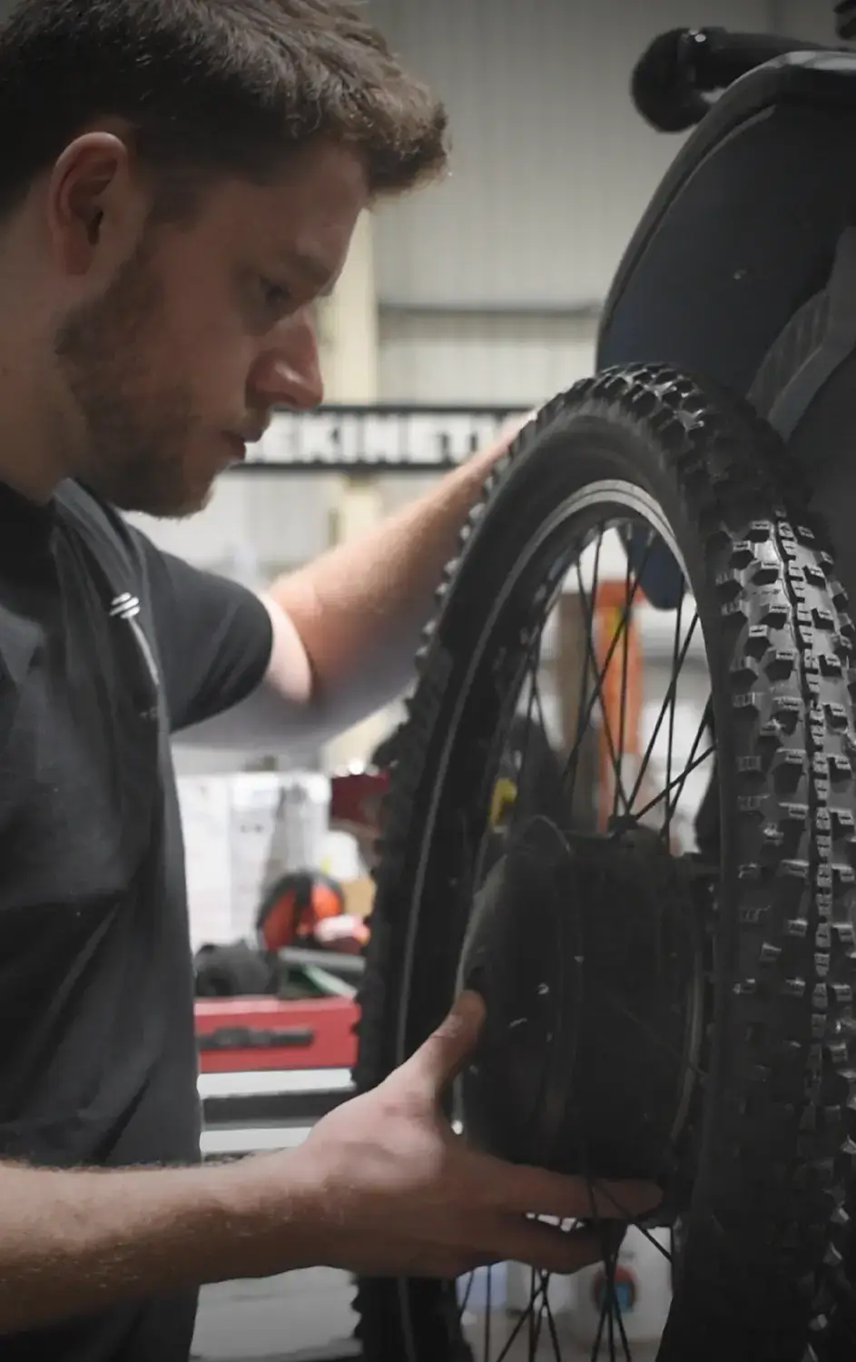 Service team putting a wheel on a wheelchair