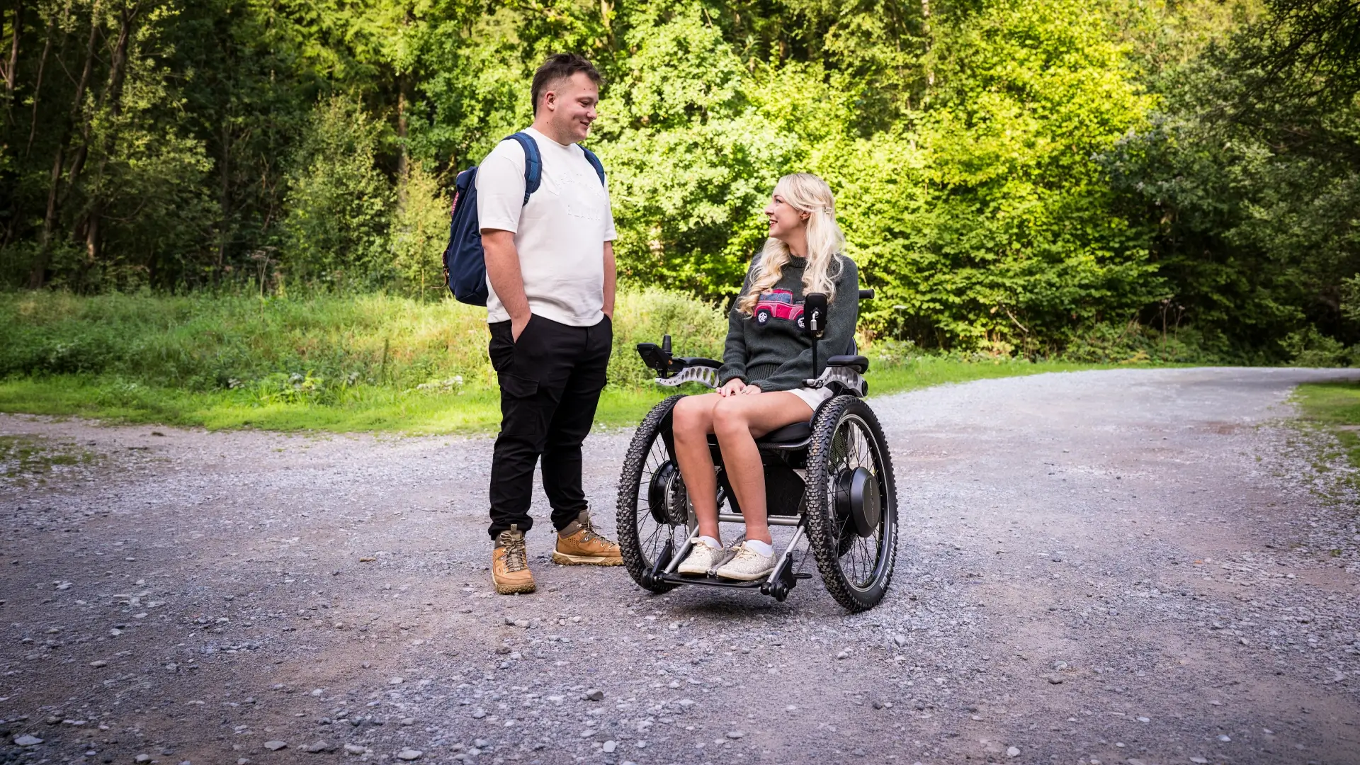 A Trekinetic user chatting with a friend on a forest track