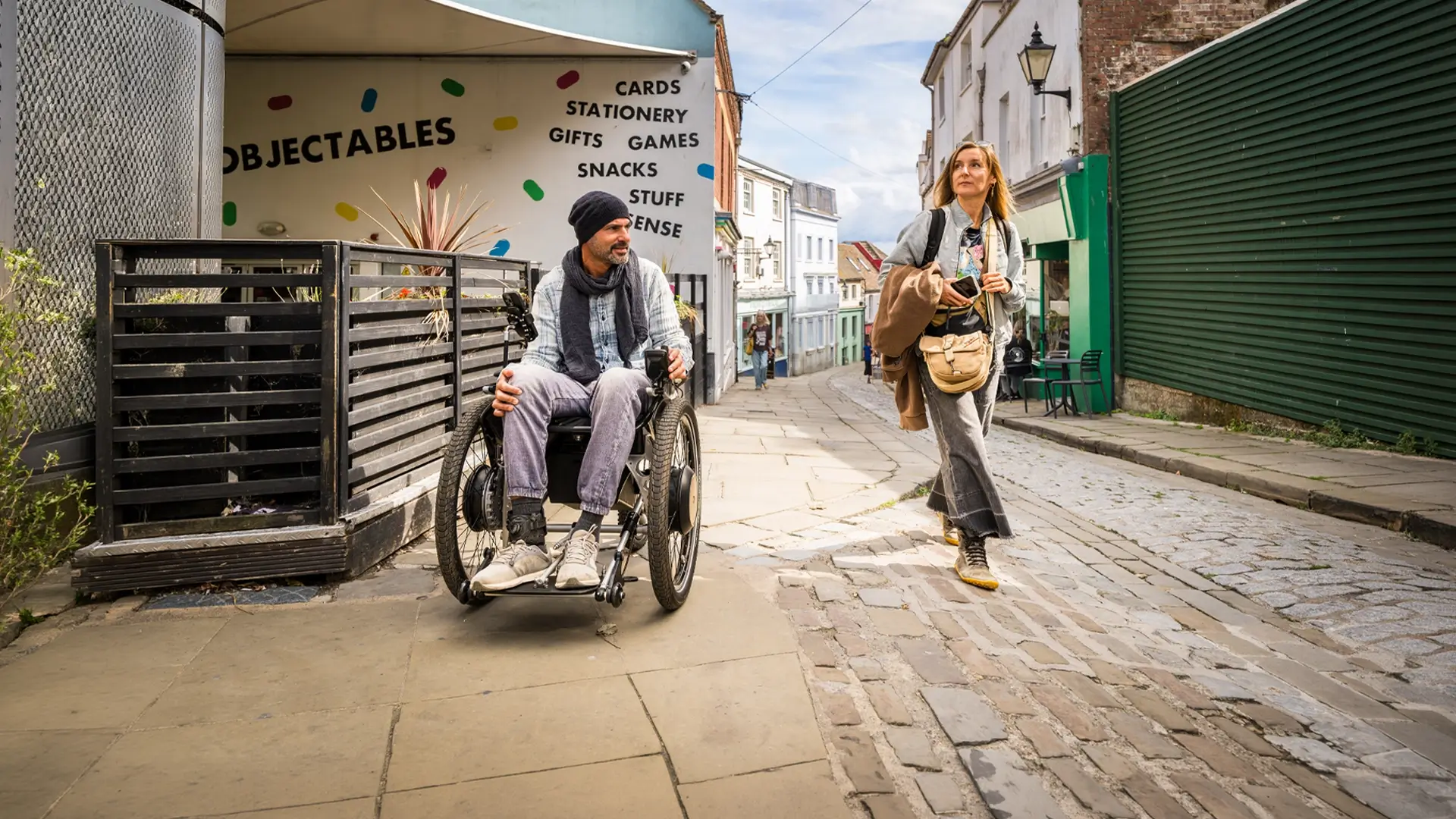 A Trekinetic user in town on a cobbled street